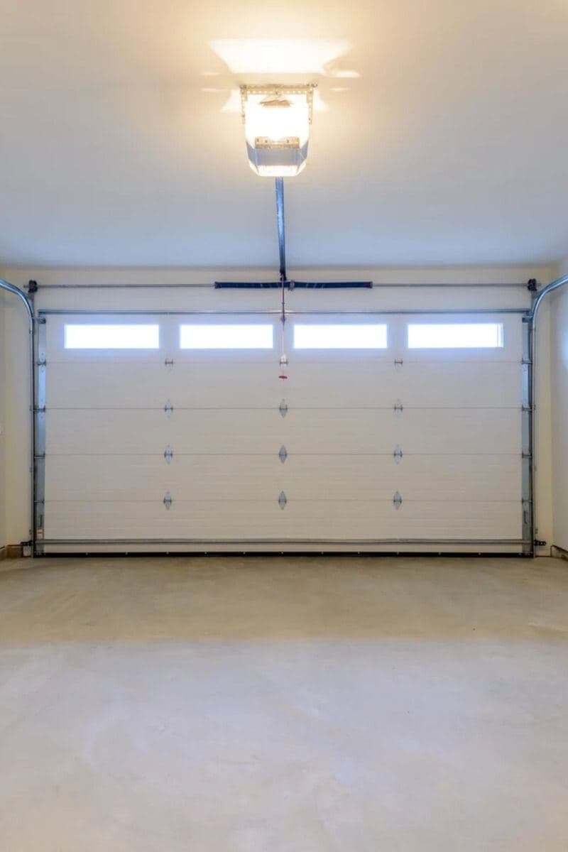 Clean white garage with ceiling-mounted opener
