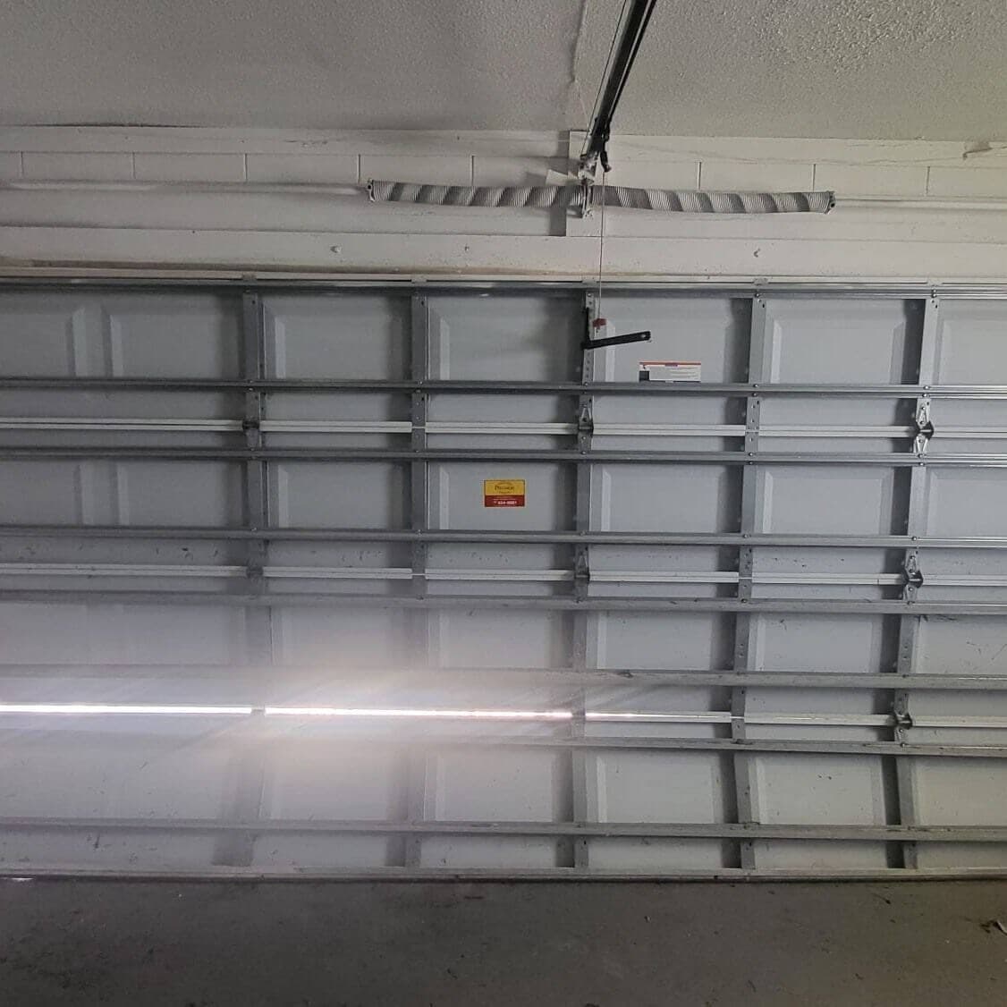 Garage door frame and strut reinforcement