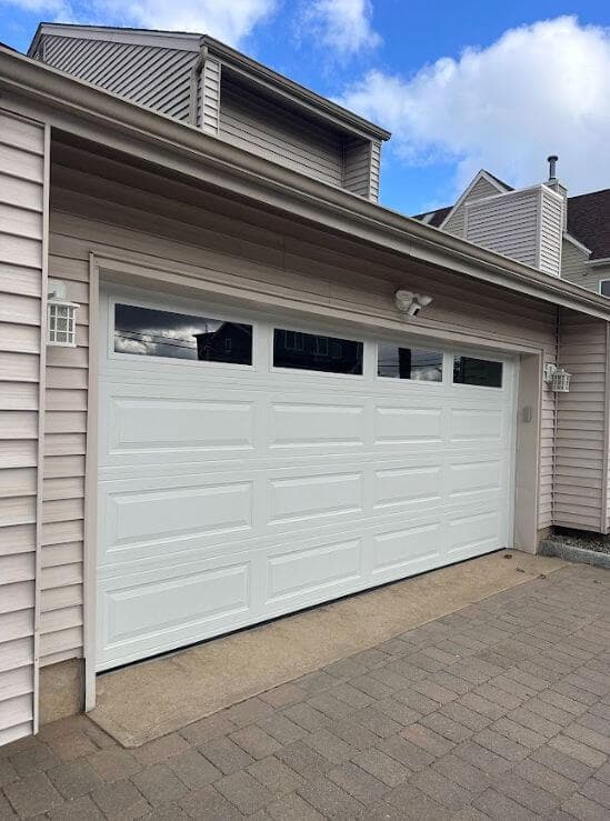 White raised-panel garage door exterior view